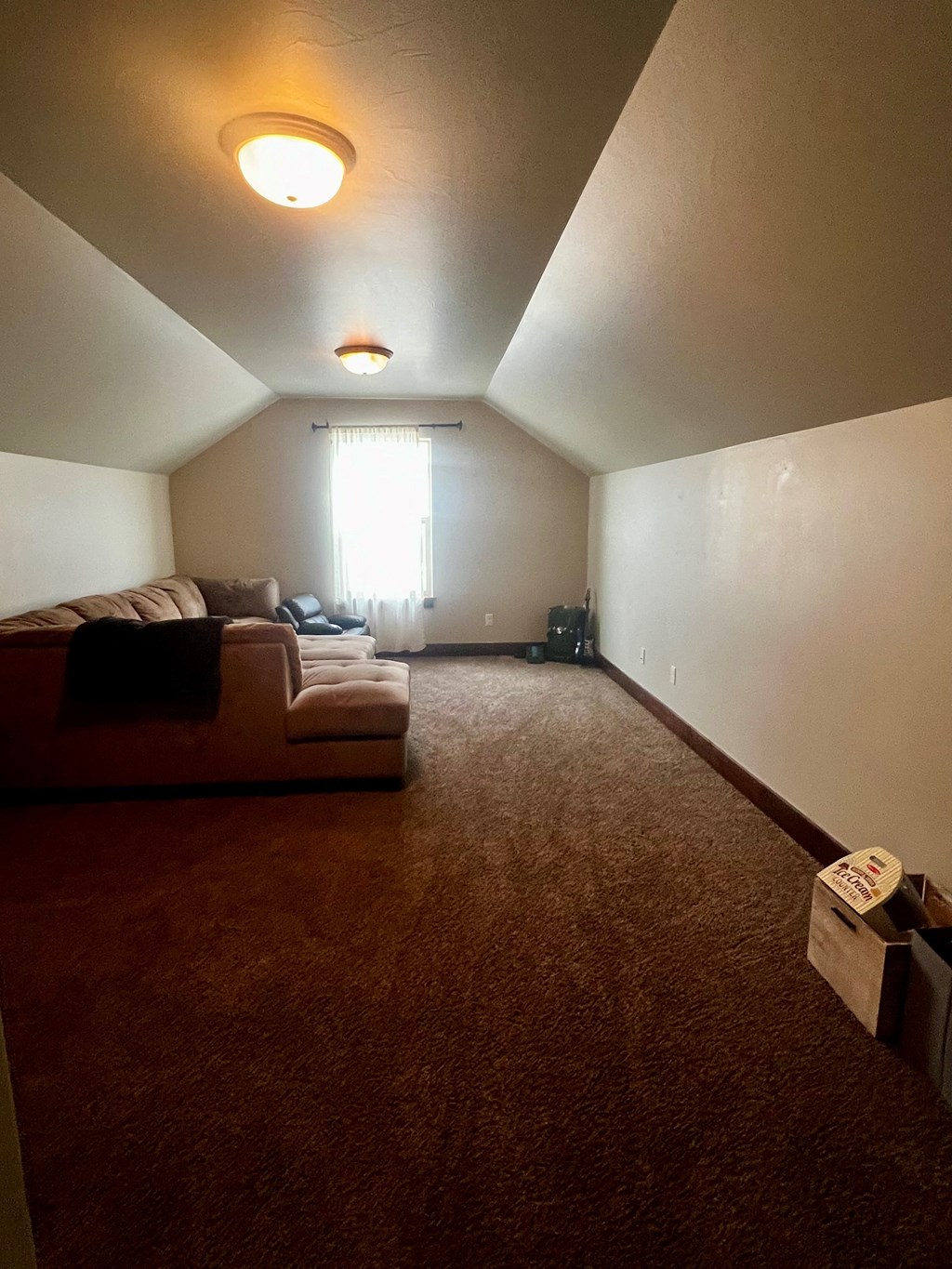 a living room with a couch and a window