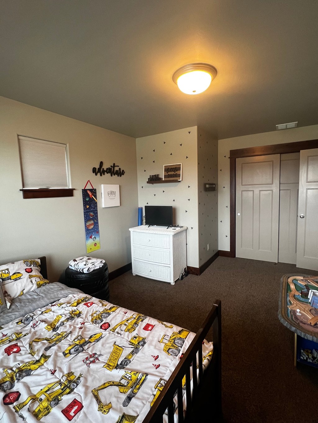 a bedroom with a bed and a dresser in it