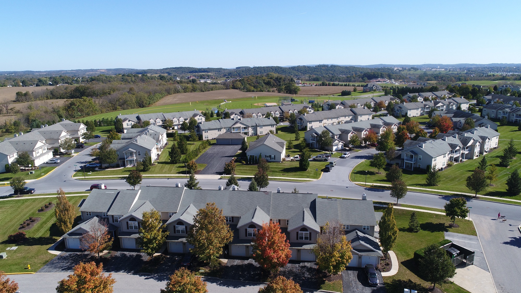 an aerial view of a neighborhood of houses with trees