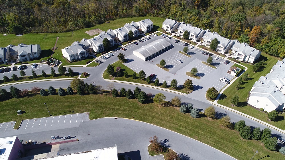 an aerial view of a neighborhood with houses and parking lot
