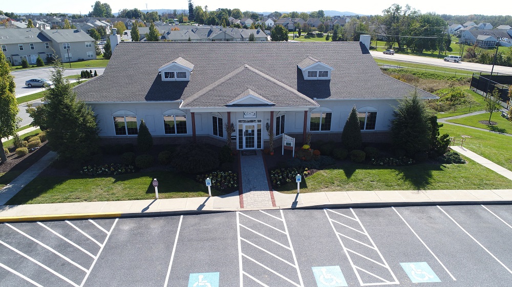 an aerial view of a large house in a parking lot