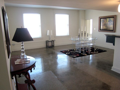 a dining room with a table and chairs in the middle of a living room