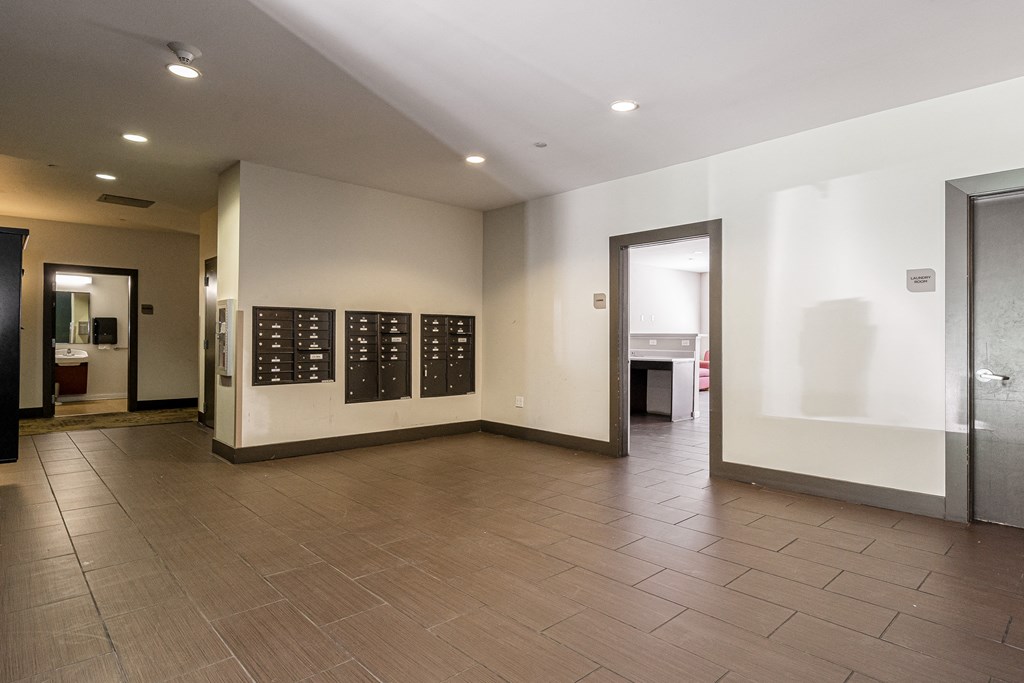an empty room with a door and a wall with a calendar on it