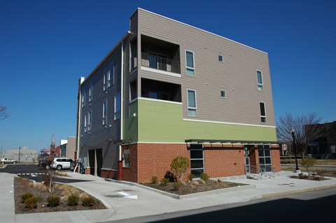 a new apartment building is shown on the corner of a street