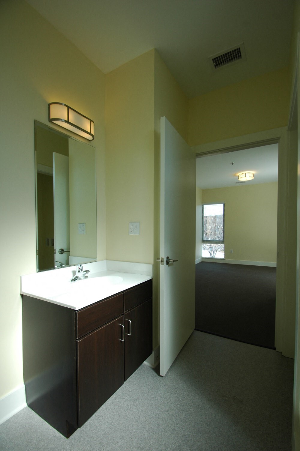an empty bathroom with a sink and a mirror