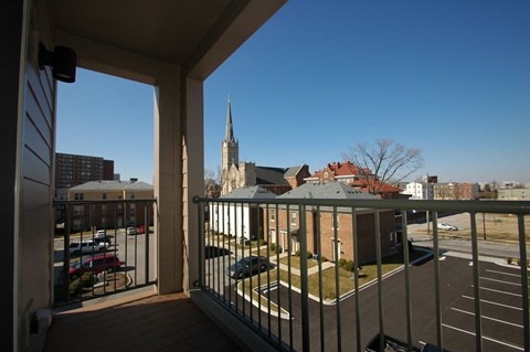 a view of the city from the balcony of a condo