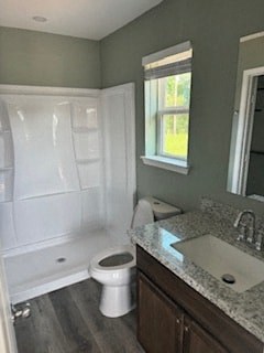 A white toilet sits in a bathroom next to a sink.