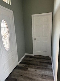A hallway with a white door and a window.