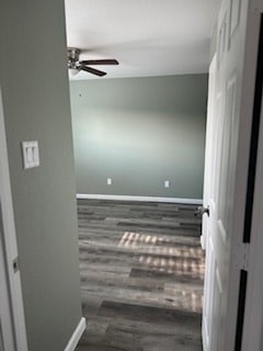 A room with a ceiling fan and a door.