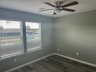 A room with a ceiling fan and a window with blinds.