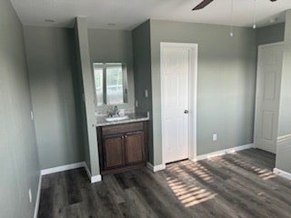 A room with a wooden floor and a white door.