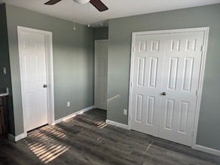 A room with a white door and a ceiling fan.