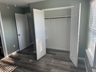 A room with a white door and a window with blinds.