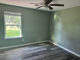 A room with a ceiling fan and a window.
