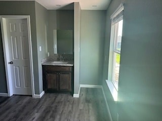 A bathroom with a wooden vanity and a white door.