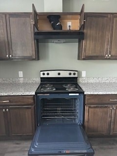 A black oven with the door open in a kitchen.