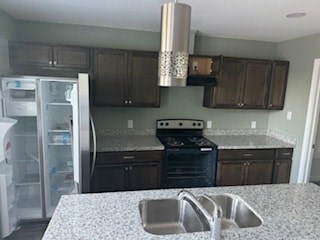 A kitchen with a granite counter top and stainless steel appliances.