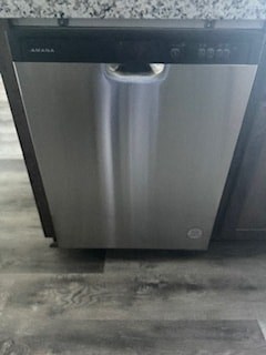 A dishwasher is sitting on a kitchen floor.