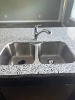 A double sink in a granite counter top.
