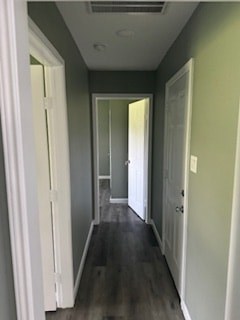A long hallway with white doors on both sides.