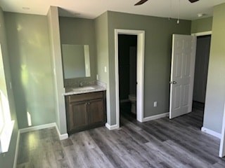 A room with a wooden floor and a white door.