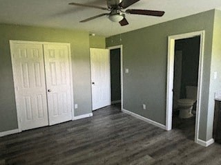 A room with a ceiling fan and a toilet in the corner.