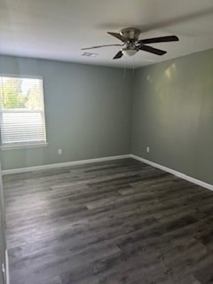 A room with a ceiling fan and wooden flooring.
