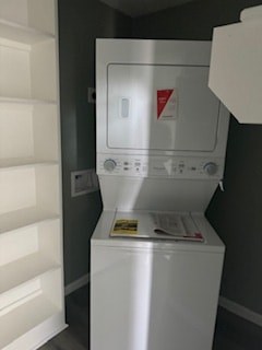 A white washing machine sits in a laundry room.
