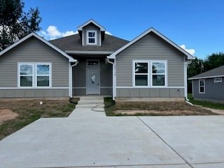 A grey house with a white door and windows.