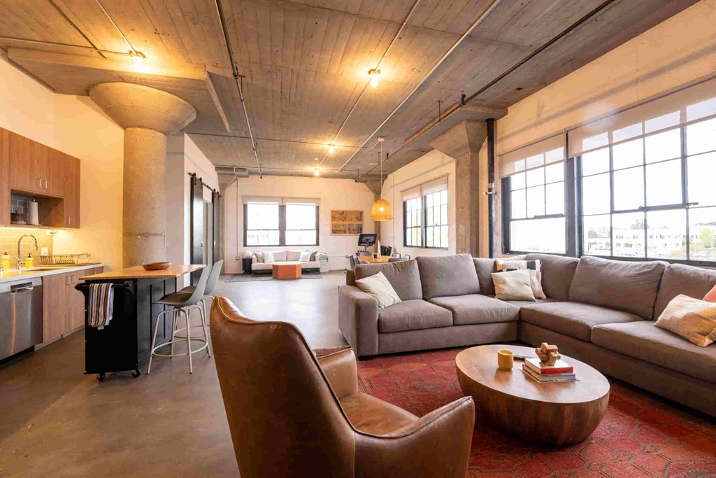 the living room of a loft with couches and a coffee table