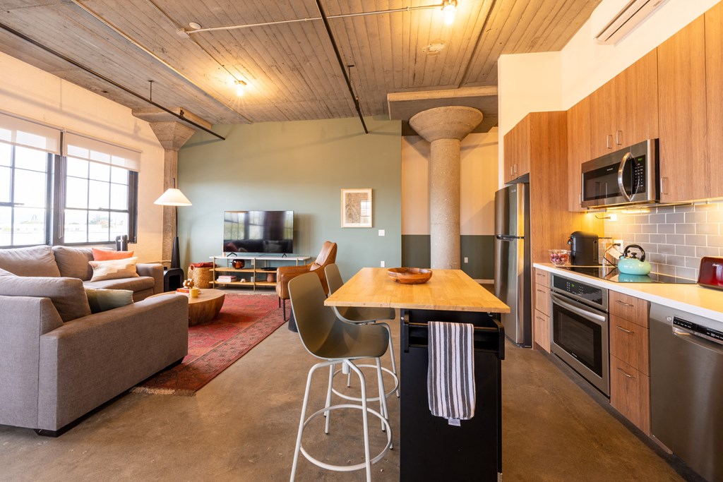 a living room with a kitchen and a dining table