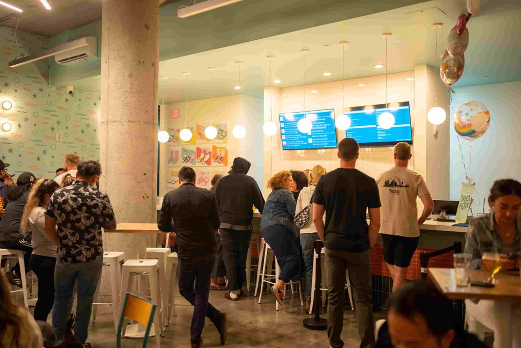 a group of people standing in a restaurant