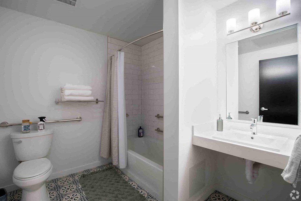 a bathroom with a toilet and a sink and a shower