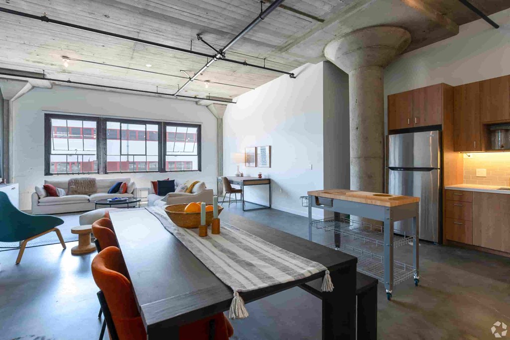 a large living room with a dining table and a kitchen
