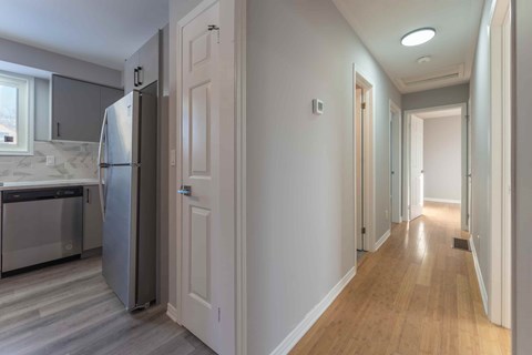A kitchen with a refrigerator and a dishwasher.