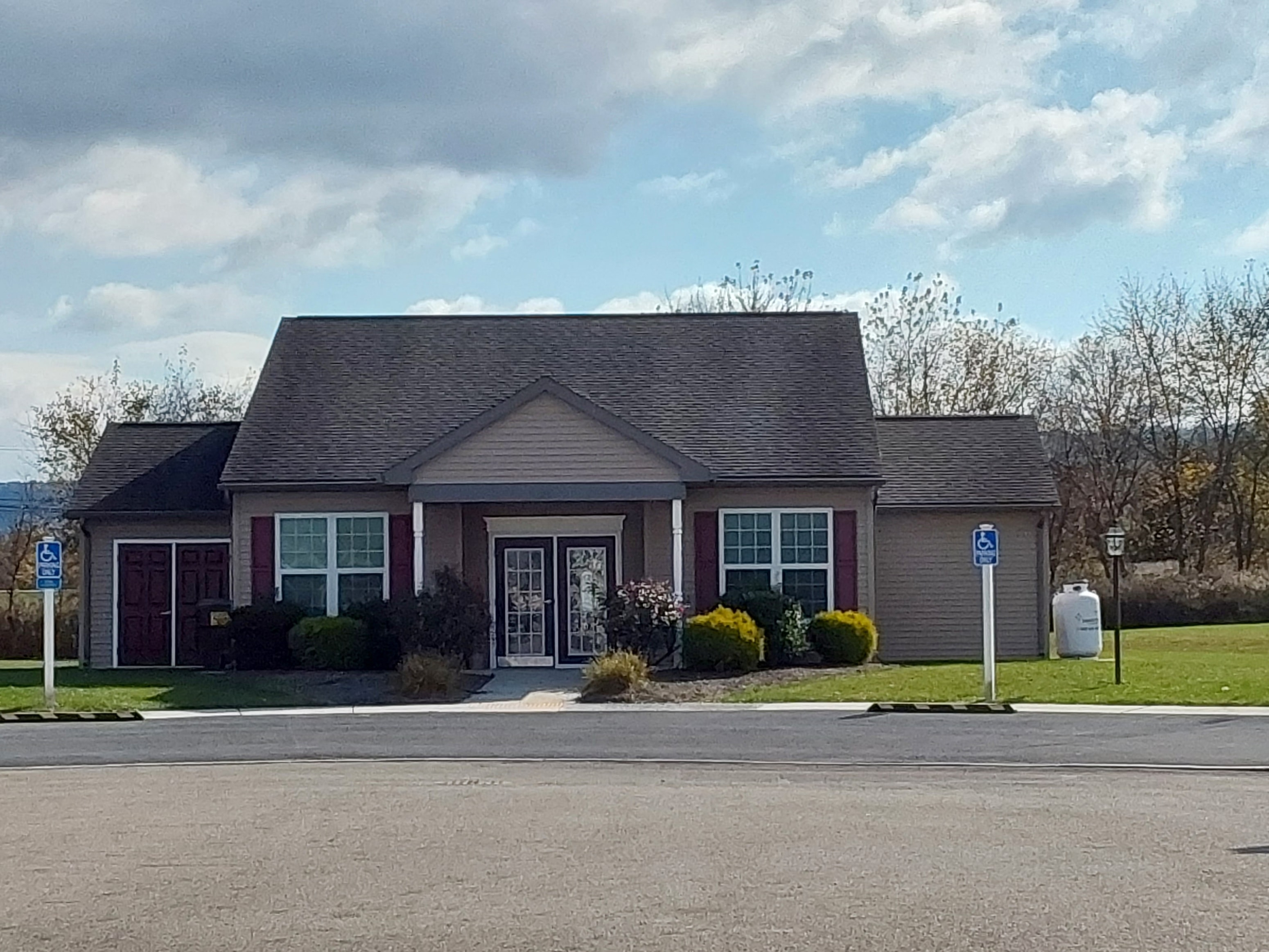 a house with a driveway and a street sign
