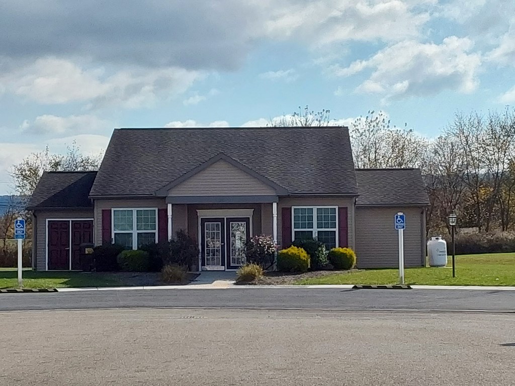a house with a driveway and a street sign