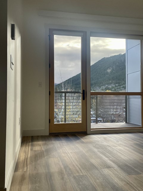 a view of the mountains from the living room of a new home