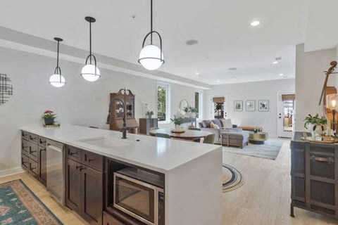 a large kitchen with a center island and a living room