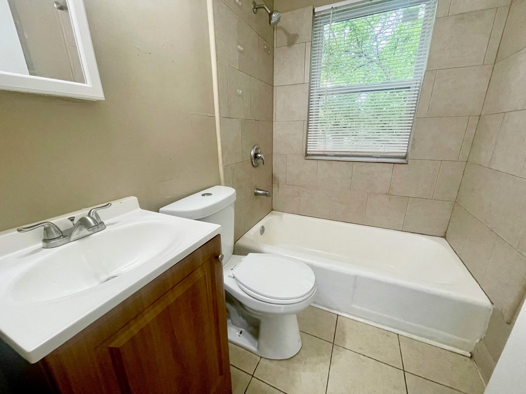 a bathroom with a sink toilet and a tub