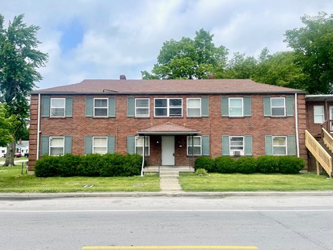 a brick apartment building on the side of a street