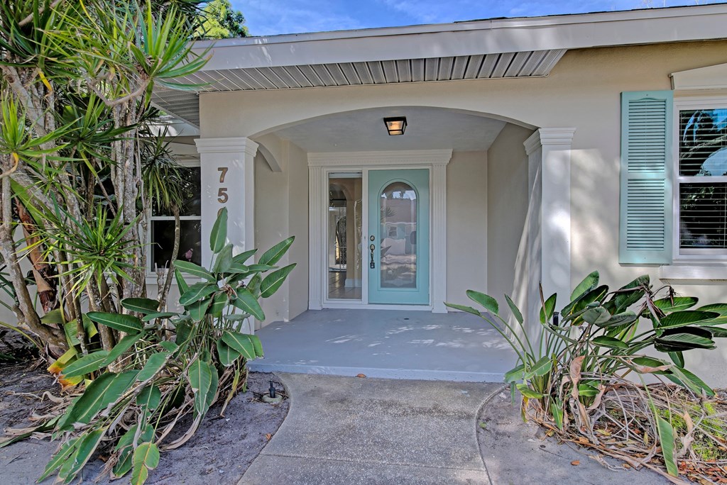 the front entrance of a house with a blue door