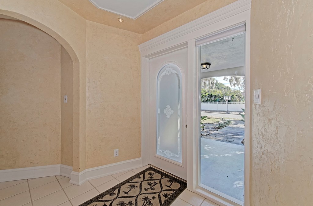 a dining room with a door to the yard and a rug