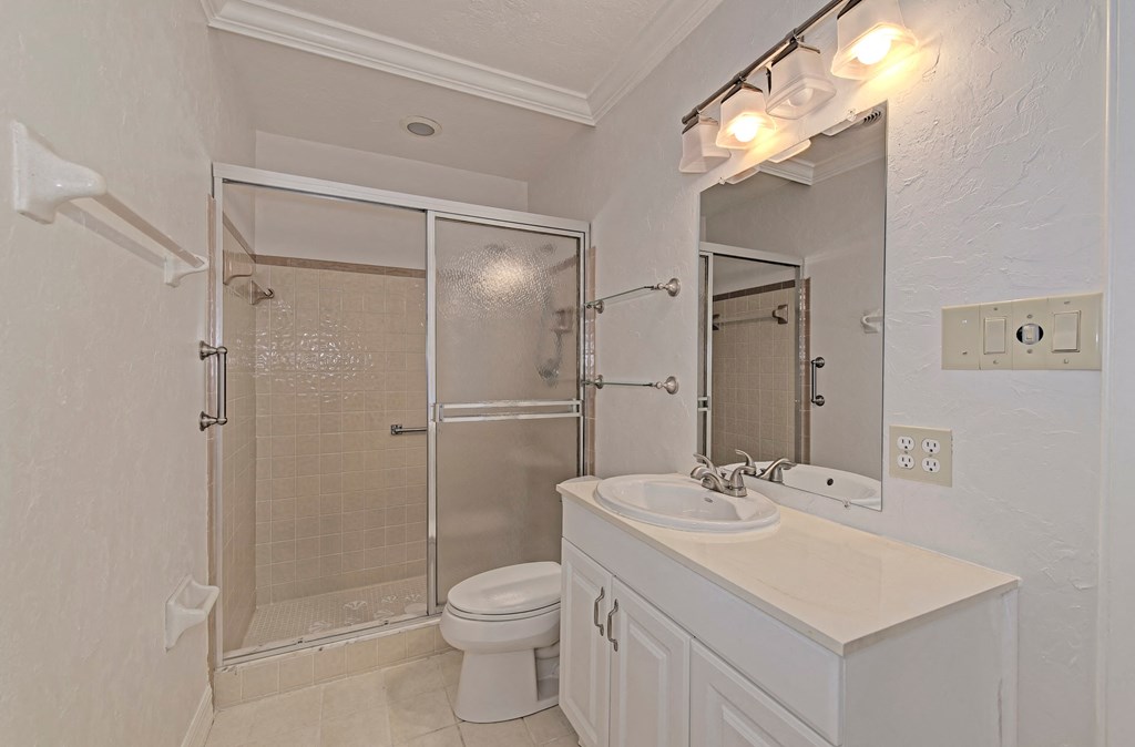 a bathroom with a shower sink and toilet