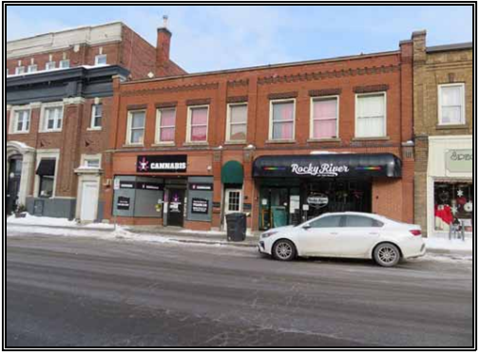 a white car parked in front of a building