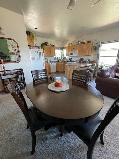 a kitchen and dining room with a table and chairs