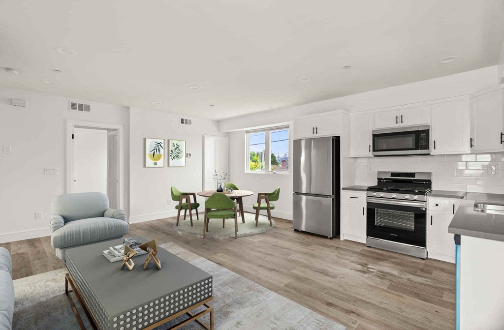 a living room with a kitchen and a table with chairs