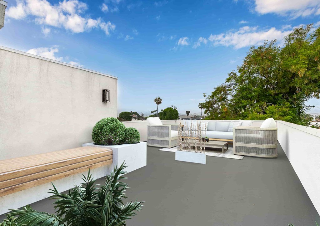 a roof terrace with couches and a table and chairs
