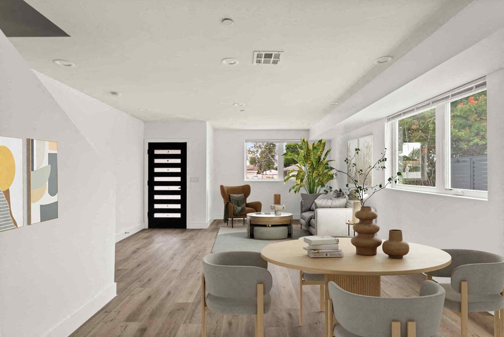 a living room and dining room with a table and chairs