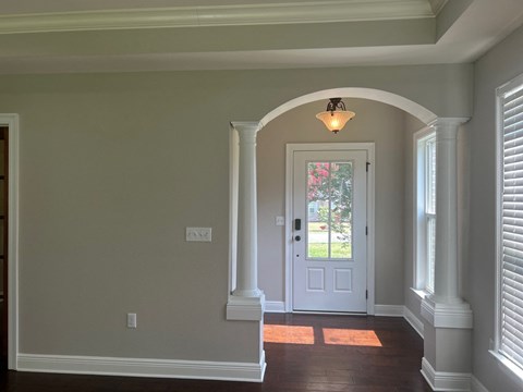 a view of the entryway of a house with a white door